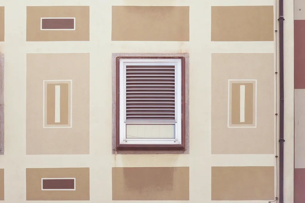 Ventilation grille set into a beige exterior wall